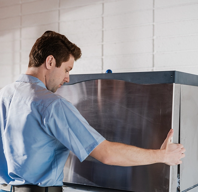 Mr. Appliance service professional inspecting an ice machine.