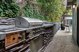 Close up of silver grill in outdoor kitchen.