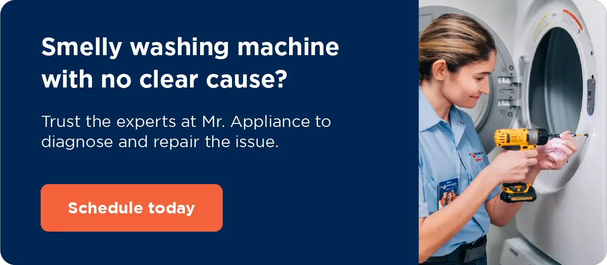 A service professional working on a washing machine with copy: Smelly washing machine with no clear cause? Trust the experts at Mr. Appliance to diagnose and repair the issue. Schedule washer service.