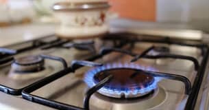 gas burner with blue flame on stovetop