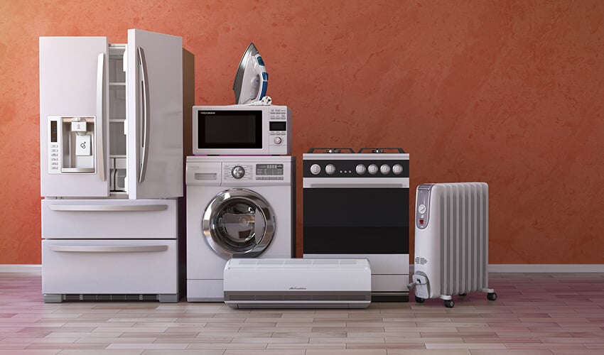 Refrigerator, dryer, microwave, stove, and other appliances lined against a wall