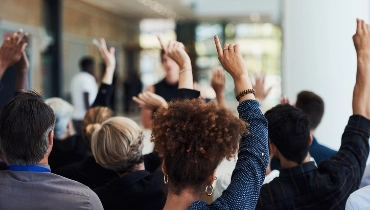 A group of people raising their hands.