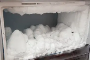 Freezer with ice buildup on walls.