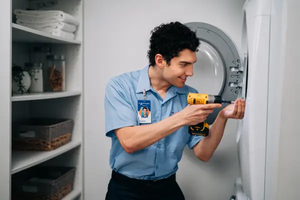 A Mr. Appliance service professional performing a dryer repair.