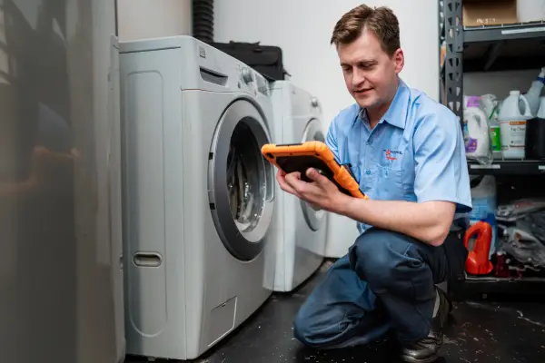 A Mr. Appliance service professional inspecting a dryer that won&rsquo;t spin.