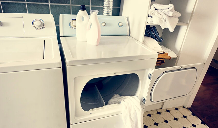 White side-by-side washer and dryer with the front-loading dryer's door open.