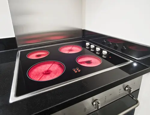 Electric stovetop with four active cooking surfaces.