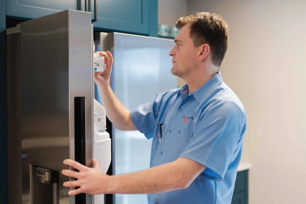 Service professional working on a freezer.